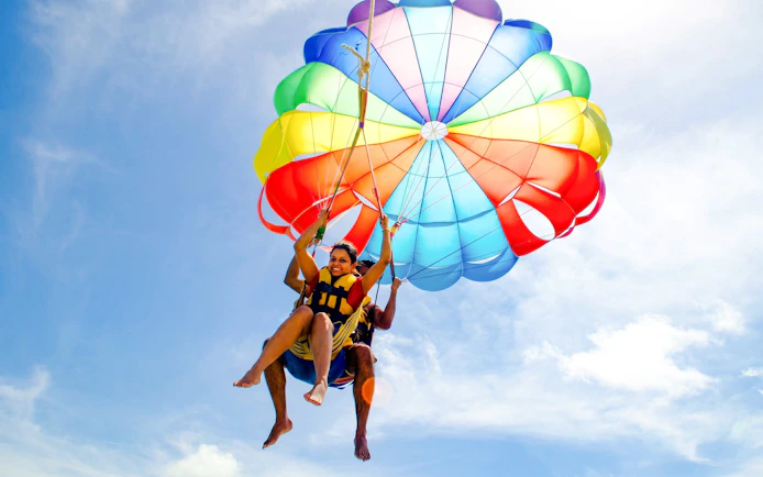 Parasailing adventure on the east coast of Mauritius with colorful parachute.