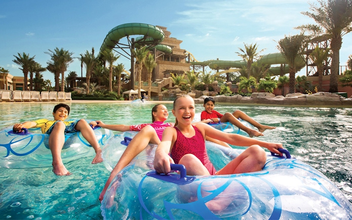 Children enjoying water rides at Aquaventure Waterpark, Atlantis The Palm, Dubai.
