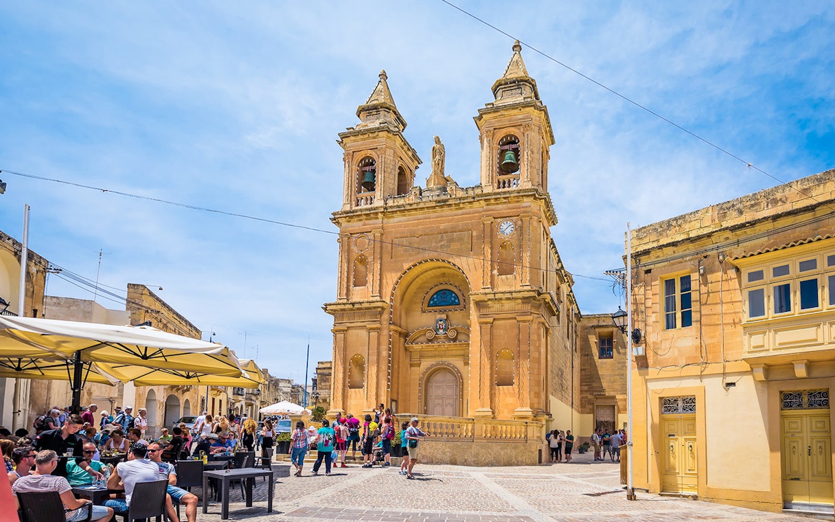 Church facade with tourists in a Maltese square, part of the Prehistoric Temples & Highlights of the South tour.