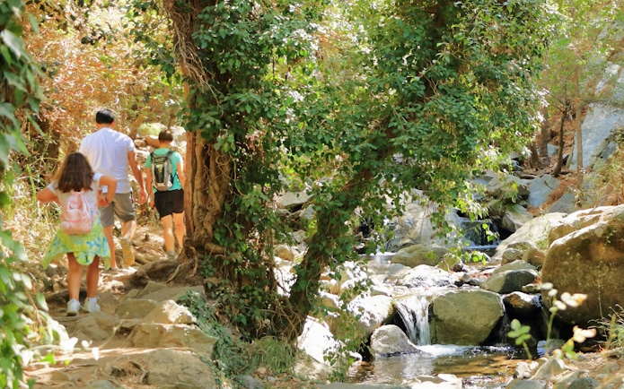 Hikers walking along the Caledonia Waterfall Trail in the Troodos Mountains, Cyprus.