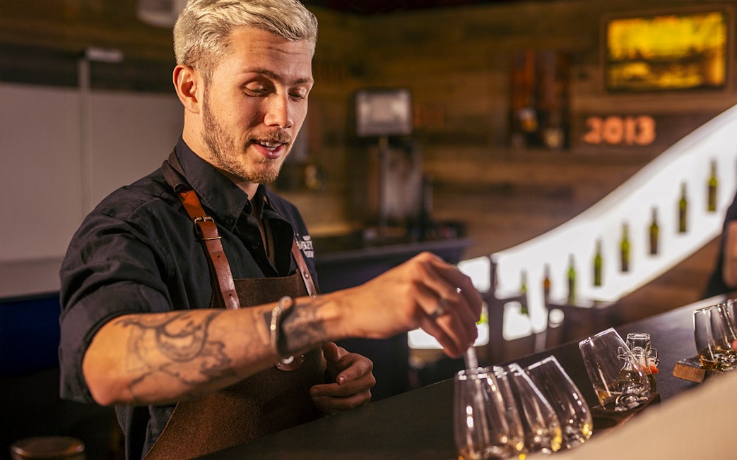 Guide demonstrating whiskey blending at the Irish Whiskey Museum.