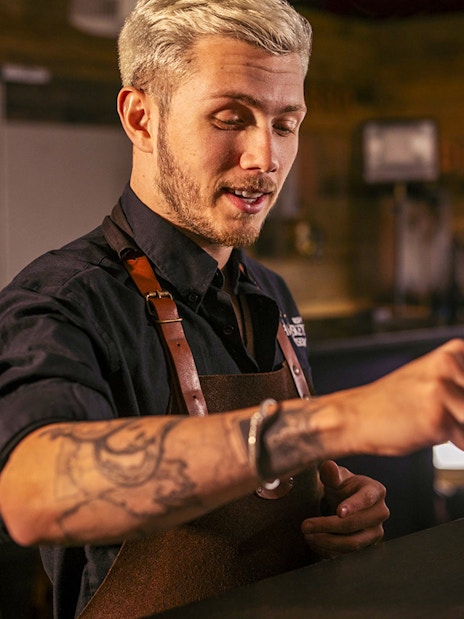 Guide demonstrating whiskey blending at the Irish Whiskey Museum.