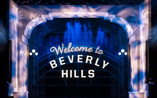 Stage set with 'Welcome to Beverly Hills' sign for Clueless The Musical