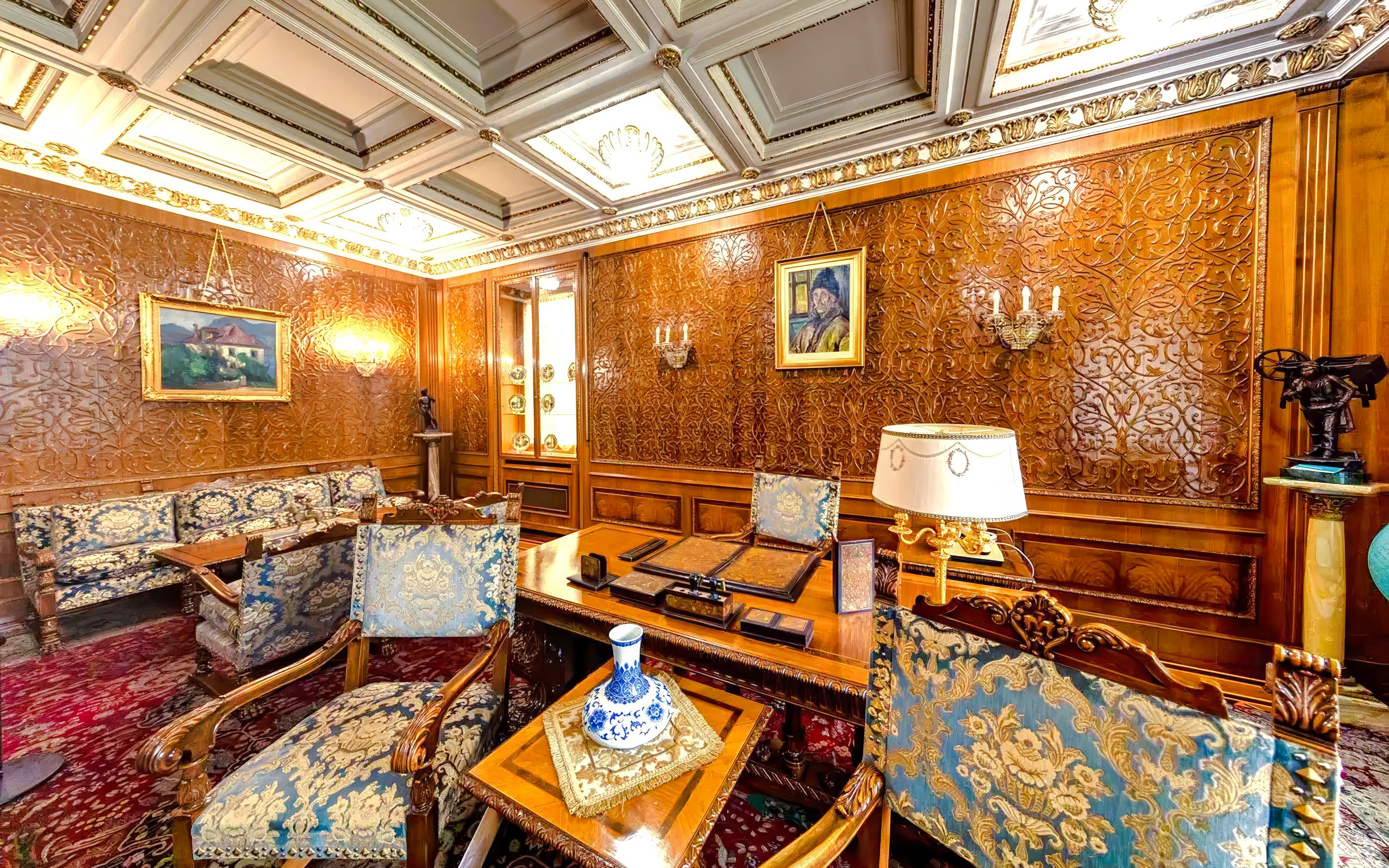 Ceausescu Mansion interior with ornate wood paneling, vintage furniture, and decorative art.