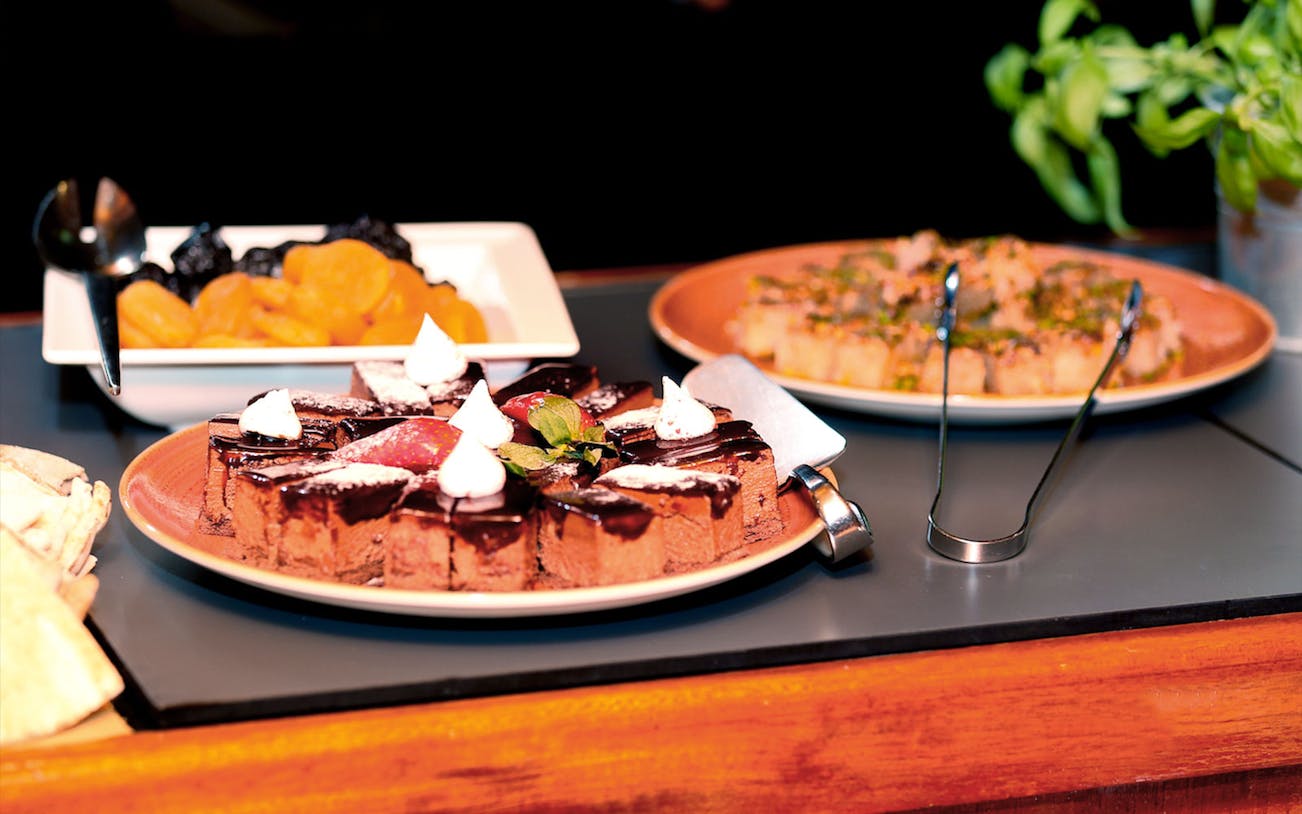 Dessert selection on Abu Dhabi Dhow Dinner Cruise buffet table.