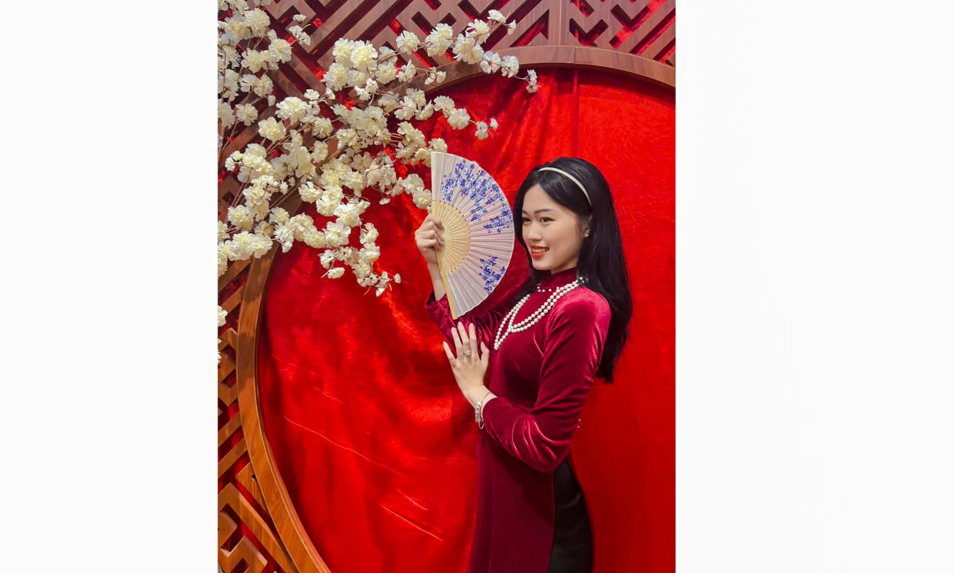 Person in traditional Ao Dai holding a fan, Da Nang cultural experience.