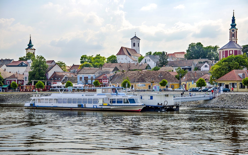 Boat docked with view of Szentendre's historic buildings and church spires.