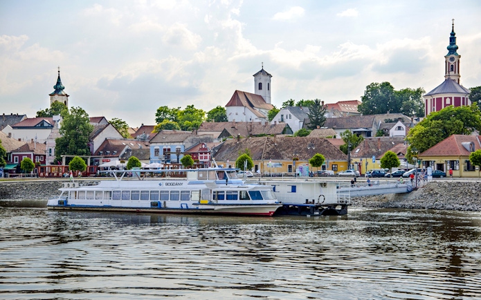 Boat docked with view of Szentendre's historic buildings and church spires.