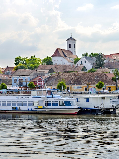 Boat docked with view of Szentendre's historic buildings and church spires.