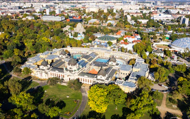 Aerial view of Szechenyi Baths surrounded by greenery in Budapest, Hungary.