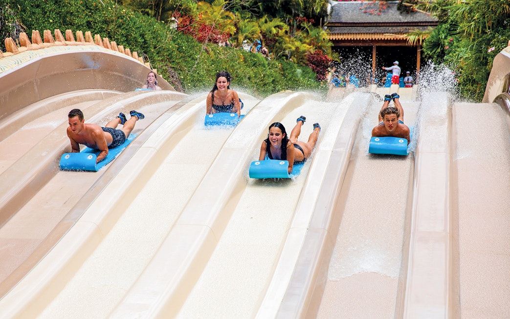 Visitors racing down water slides at Siam Park, Tenerife.