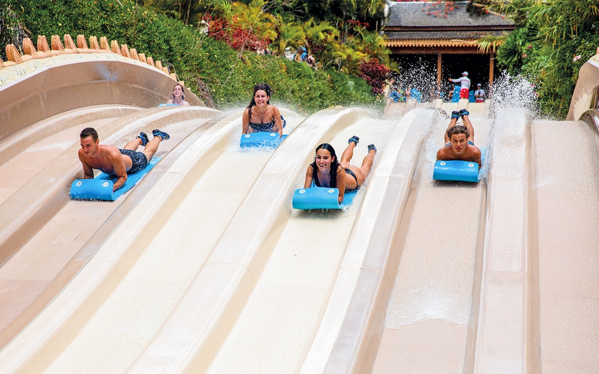 Visitors racing down water slides at Siam Park, Tenerife.