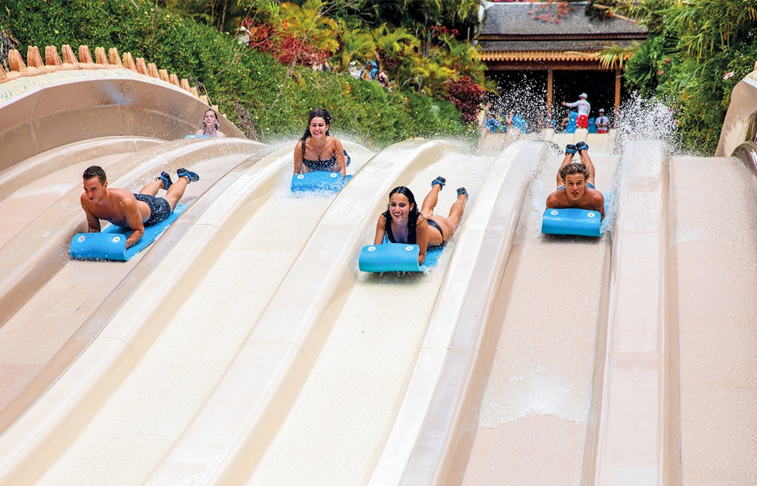naga Racer slide at Siam Park, Tenerife with people enjoying the water ride.
