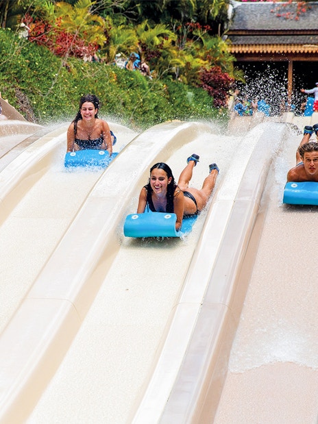 Visitors racing down water slides at Siam Park, Tenerife.