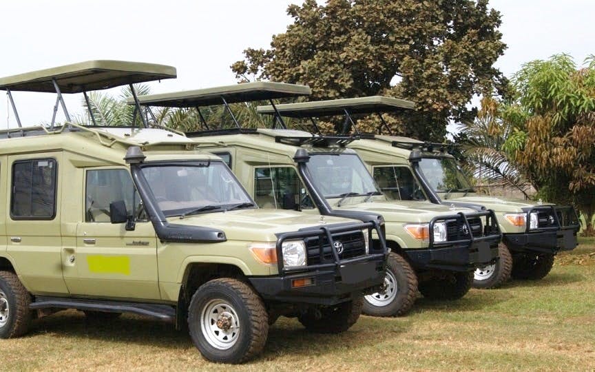 Safari vehicles lined up for Nairobi National Park tour.