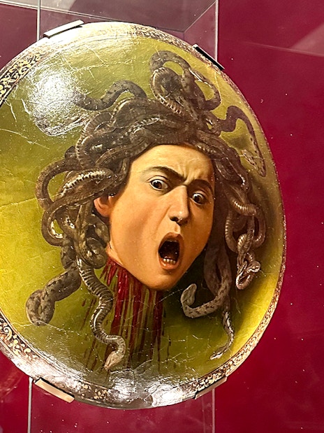 Shield featuring Medusa's head displayed in Uffizi Gallery, Florence.