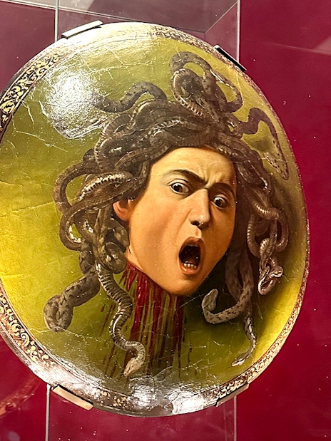 Shield featuring Medusa's head displayed in Uffizi Gallery, Florence.