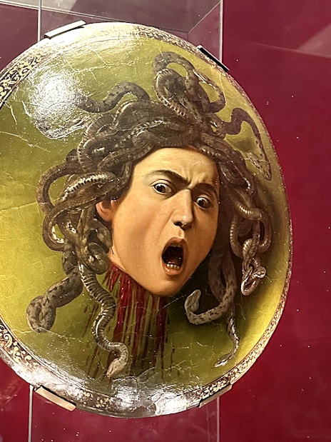 Shield featuring Medusa's head displayed in Uffizi Gallery, Florence.