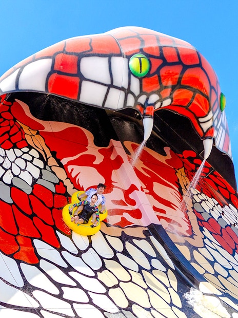 Riders on King Cobra water slide in Doha.
