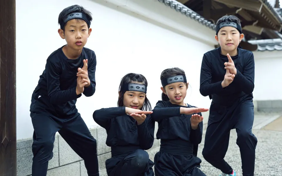 Children dressed as ninjas at Edo Wonderland Nikko Edomura, Japan.