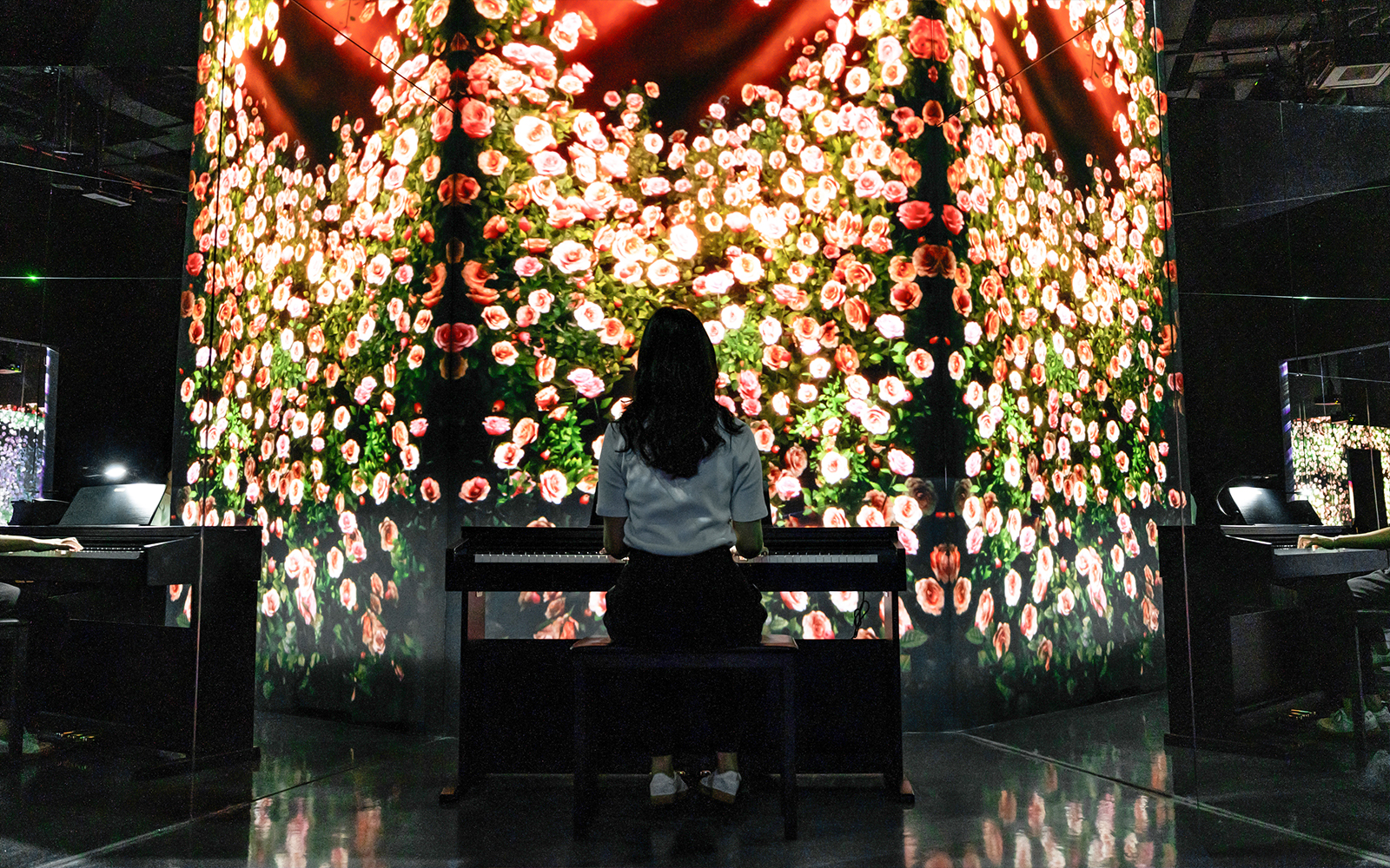 Woman at piano with rose art installation in Arte Museum Dubai.