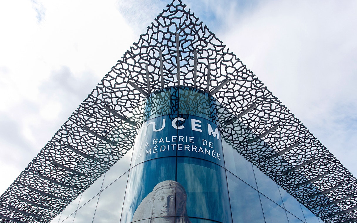 Mucem Marseille exterior with intricate lattice design and Mediterranean gallery sign.