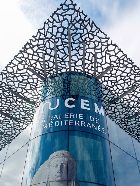 Mucem Marseille exterior with intricate lattice design and Mediterranean gallery sign.
