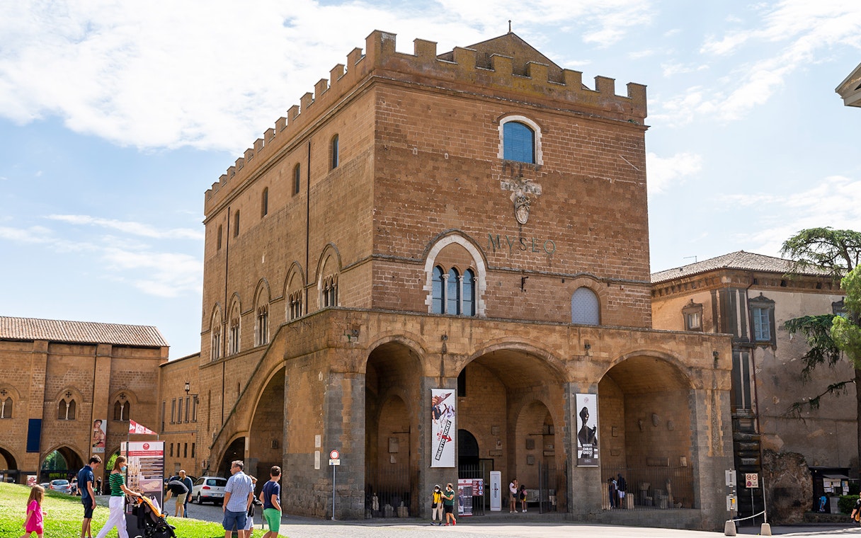 Museum of the Opera del Duomo exterior with visitors in Florence, Italy.