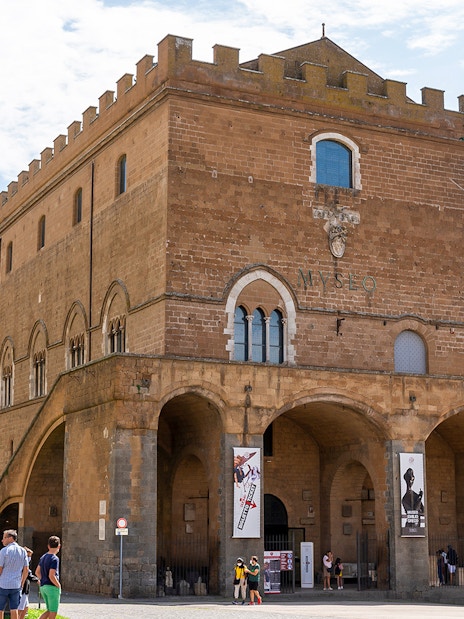 Museum of the Opera del Duomo exterior with visitors in Florence, Italy.