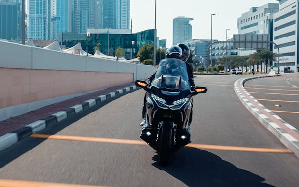 Motorcycle ride through Dubai cityscape on a premium passenger tour.
