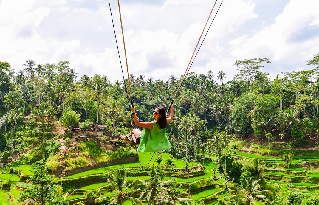 Swinging over rice terraces in Ubud, Bali, Indonesia.