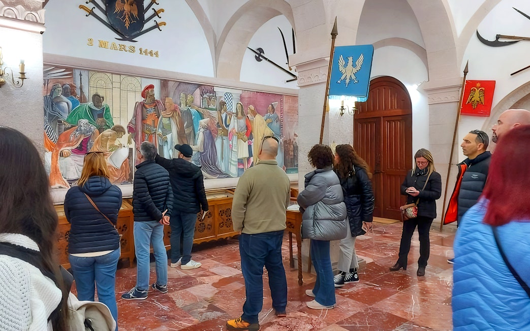 Guests viewing historical mural inside Skanderbeg Museum, Albania.