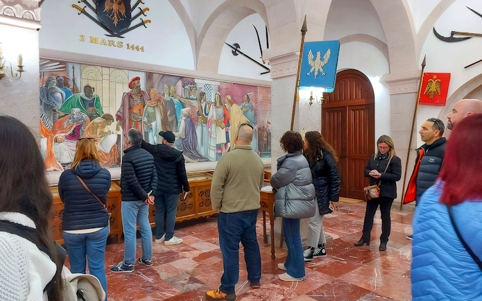Guests viewing historical mural inside Skanderbeg Museum, Albania.