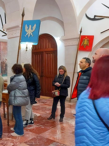 Guests viewing historical mural inside Skanderbeg Museum, Albania.