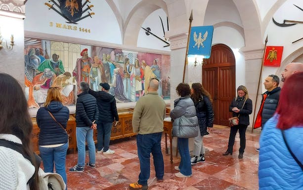 Guests viewing historical mural inside Skanderbeg Museum, Albania.