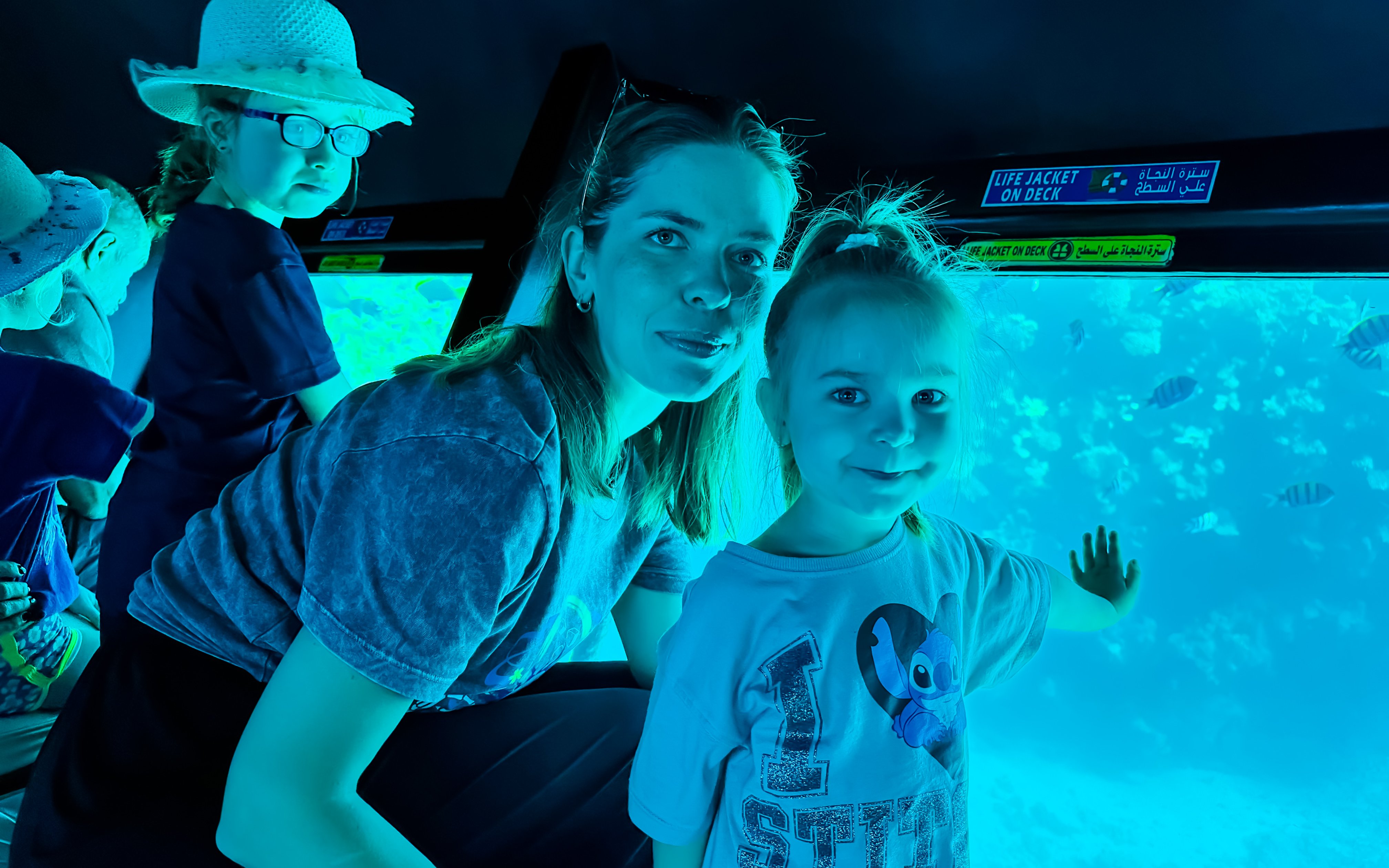 Family with kids viewing fish on Royal Seascope Submarine, Hurghada.
