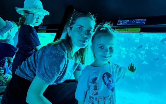 Family with kids viewing fish on Royal Seascope Submarine, Hurghada.