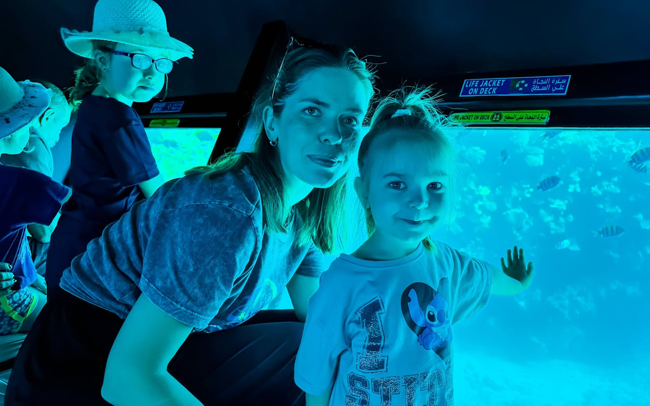 Family with kids viewing fish on Royal Seascope Submarine, Hurghada.