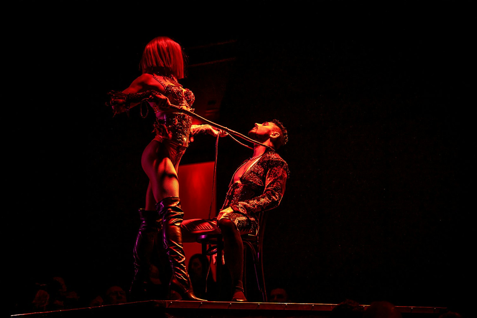 Performer in a dramatic pose during a Rouge show.