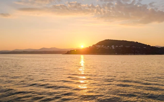 Sunset over the sea near Villefranche with distant hills and coastline.