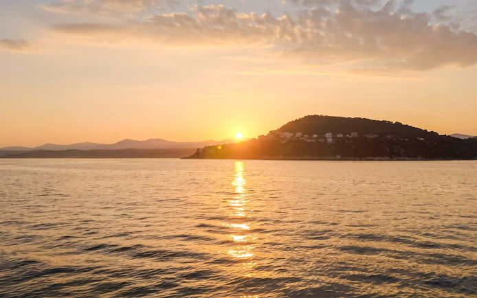 Sunset over the sea near Villefranche with distant hills and coastline.