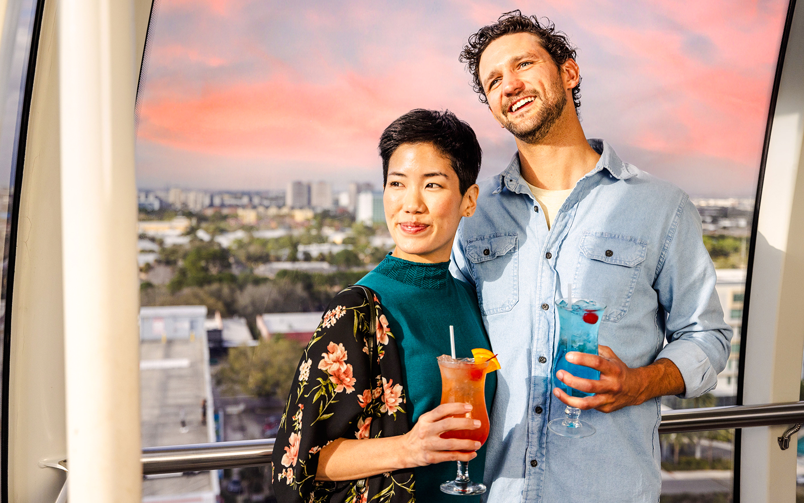 Couple enjoying drinks on the observation wheel at ICON Park, Orlando.