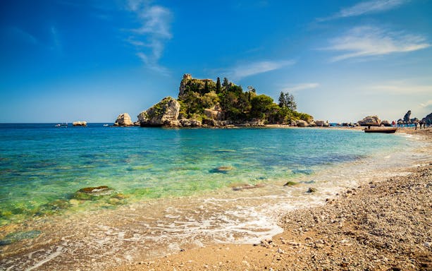 Excursion boat near Isola Bella, Giardini Naxos, Taormina coastline.