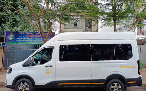 White van for private round trip transfer from Da Nang to Hoi An, parked on a street in Da Nang.