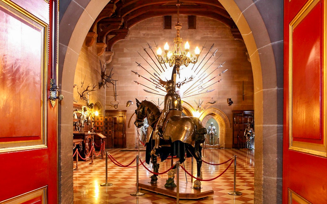 Warwick Castle interior with knight armor display and medieval decor.