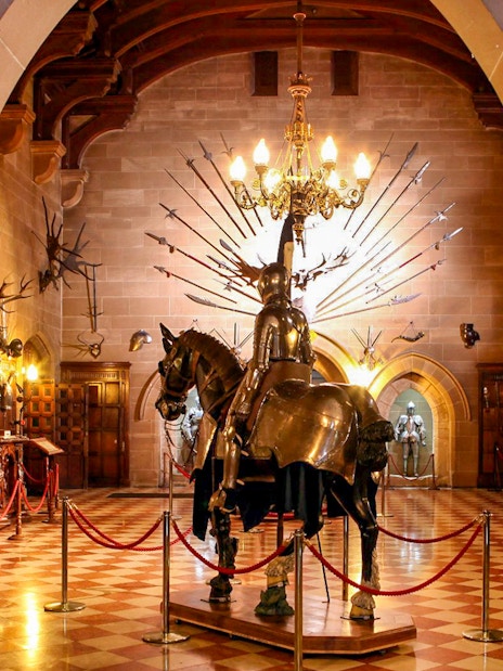 Warwick Castle interior with knight armor display and medieval decor.