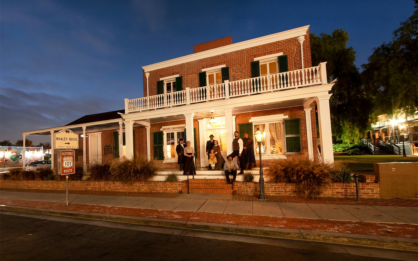 Whaley House at night with actors in period costumes, San Diego Ghosts & Gravestones Tour.
