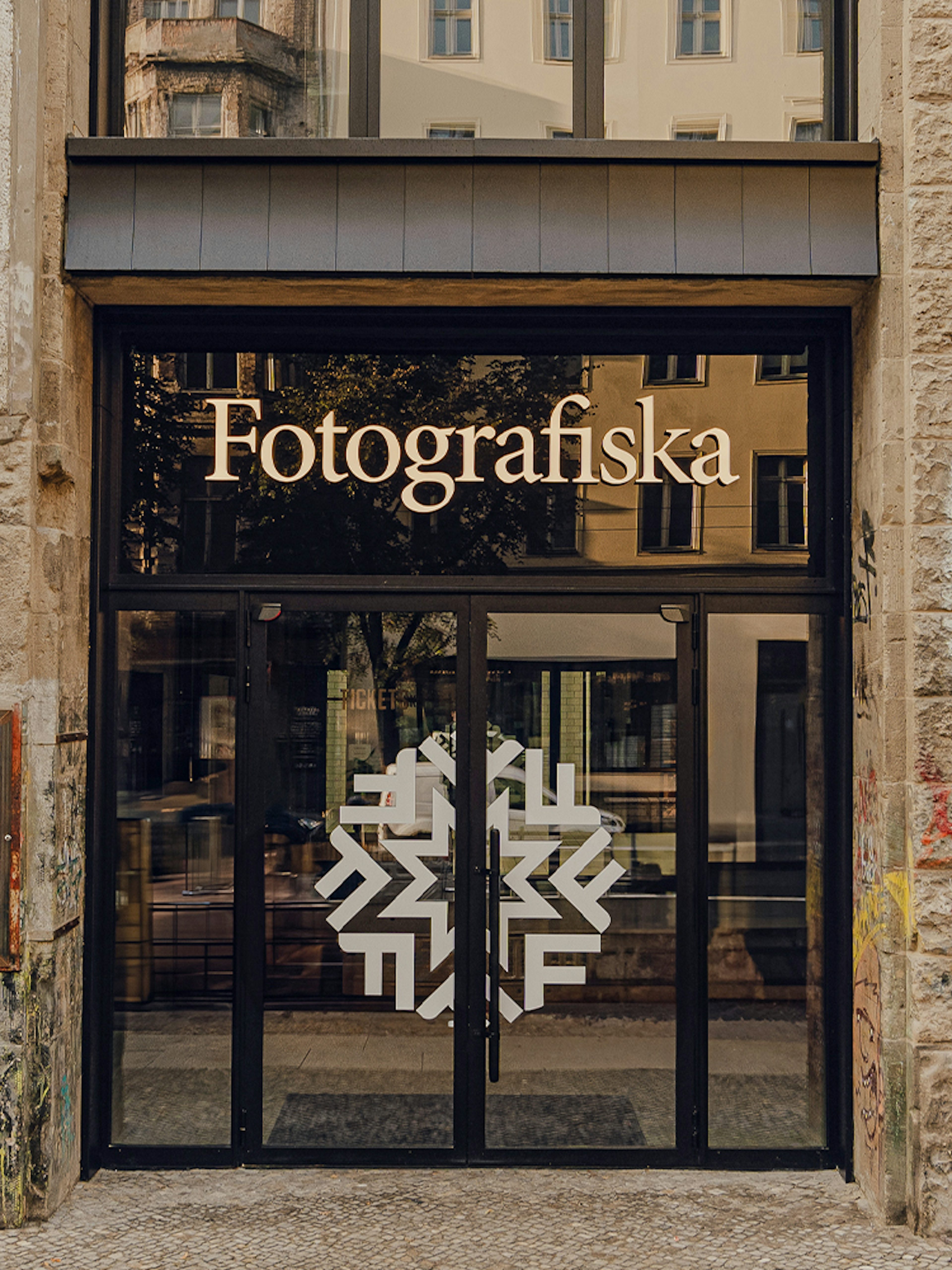 Entrance to Fotografiska Berlin with street art on the facade.