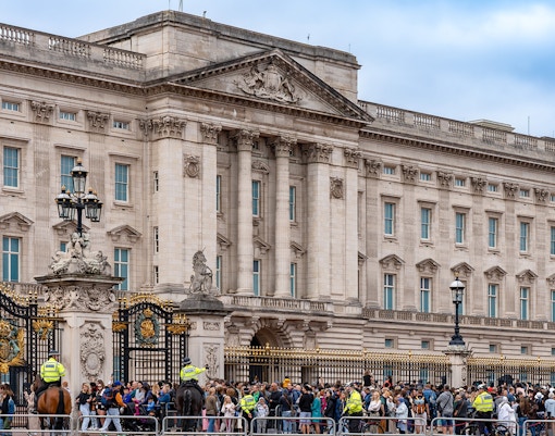 Visitors gathered at Buckingham Palace gates, London, observing the Changing of the Guard ceremony.