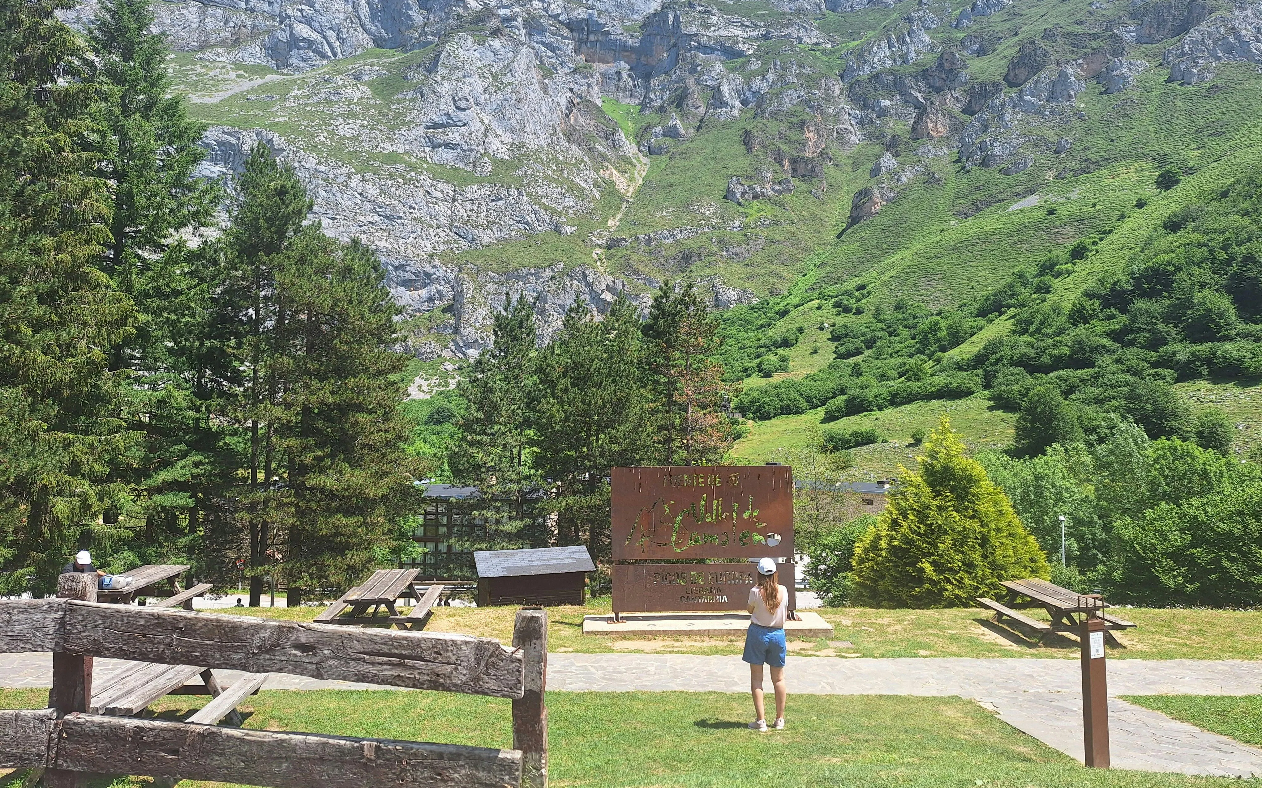 Visitor at Fuente Dé sign in Picos de Europa National Park, Cantabria, Spain, near cable car station.